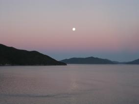 Moon rises at dusk in the Sounds